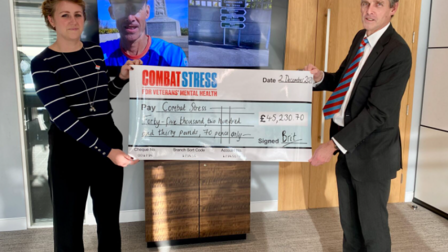 Simon Bird presents a cheque to Combat Stress